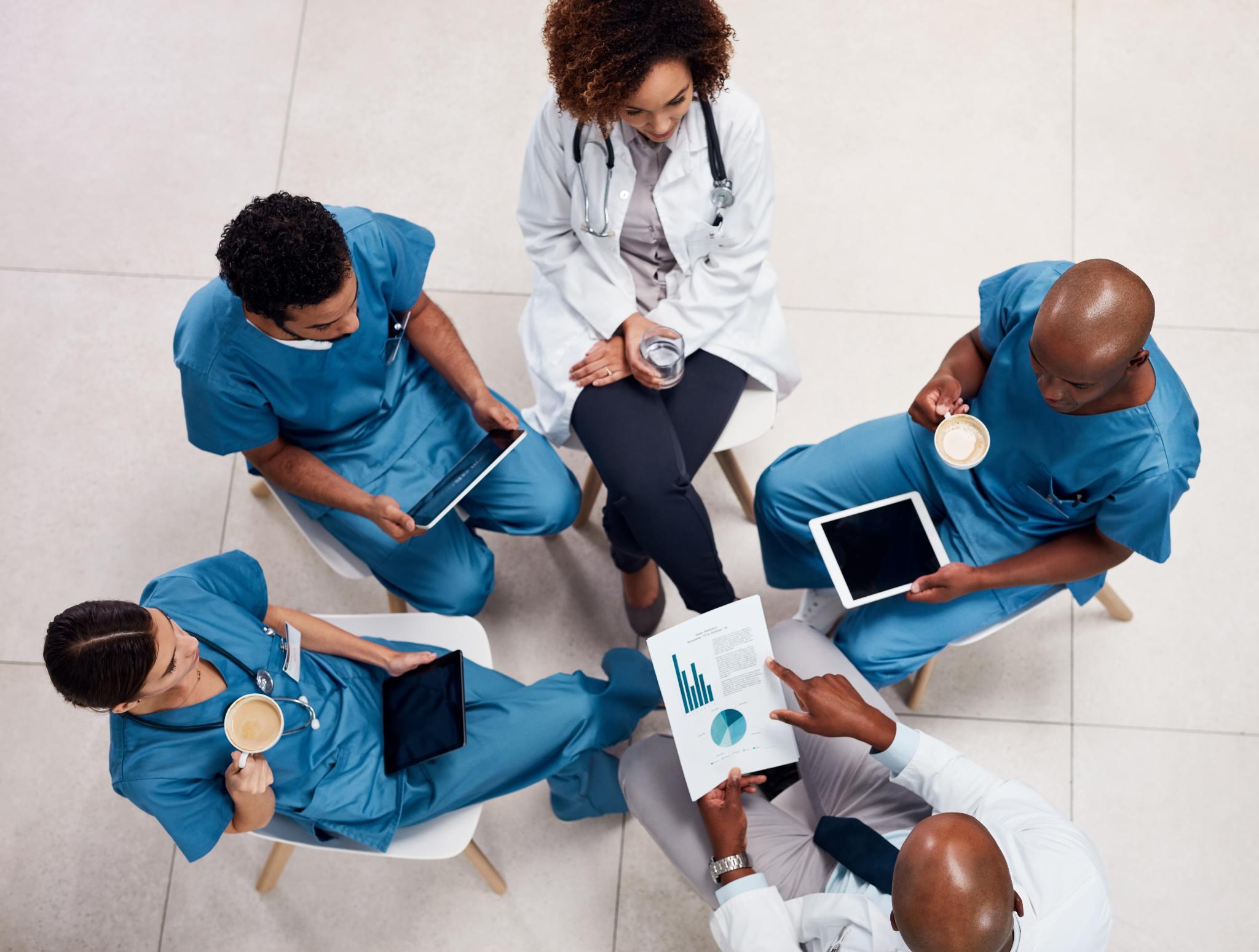 Healthcare team reviewing reports and tablets